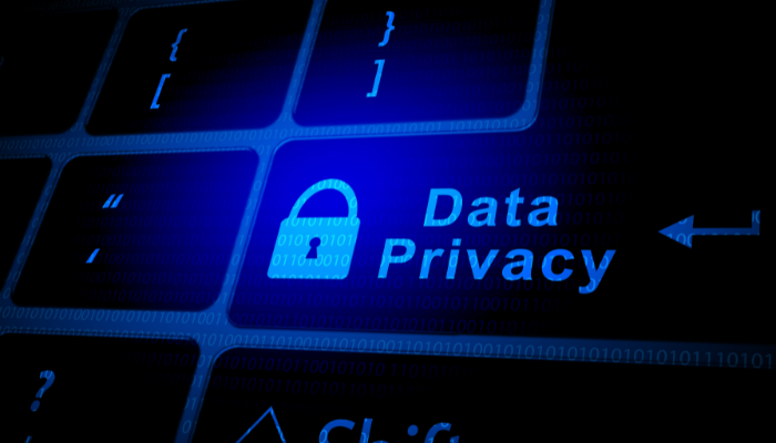 The words Data Privacy  on a keyboard with a blue background.