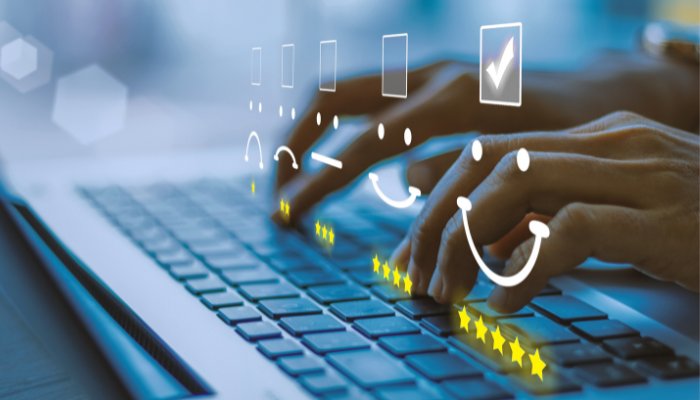 Fingers on the keys of a laptop, with smiley faces and check boxes.